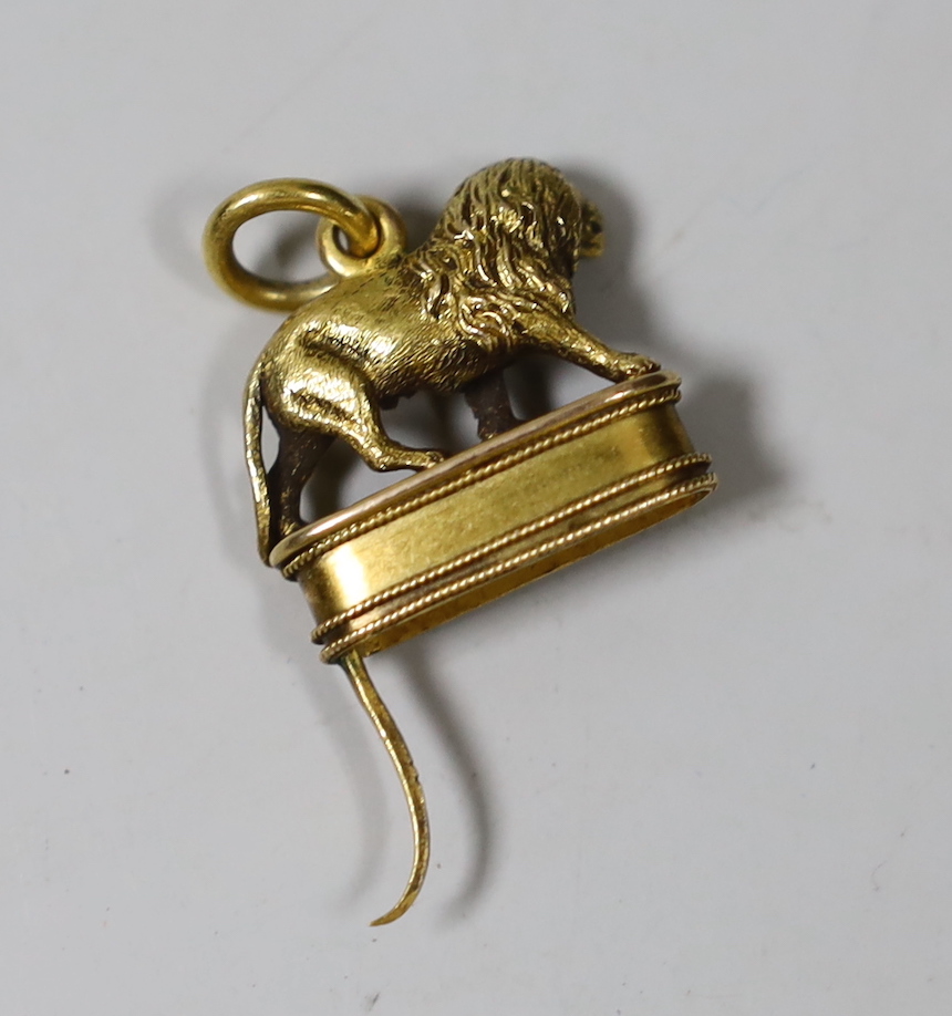 A late 19th century yellow metal scent bottle mount?, modelled as a lion en passant, height 18mm.